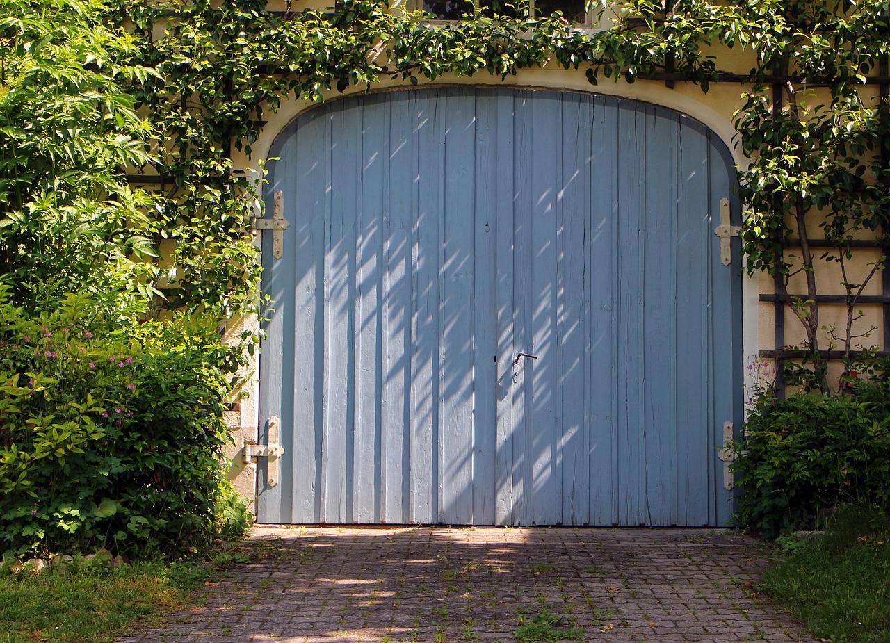 Residential garage door on a coastal street with visible sea air haze